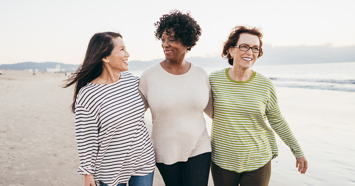 smiling women walking together - Why Women Live Longer Than Men - Axia Women's Health